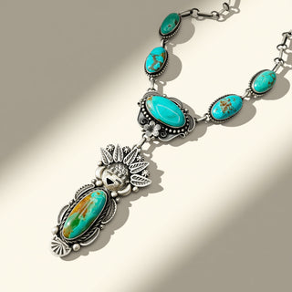 Turquoise and silver necklace on a beige background