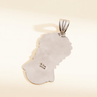 Silver pendant  with '925 Sterling' marking on a beige background