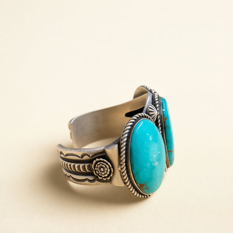 Silver cuff with turquoise stone on a beige background