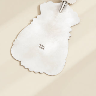Silver pendant with stamp on a beige background