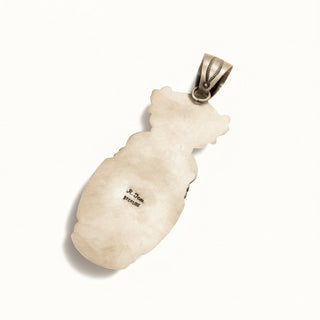 Silver pendant on a white background