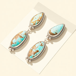 Turquoise stone earrings on a light background
