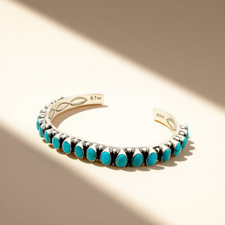 Turquoise stone cuff on a beige background