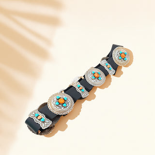 Decorative belt with metallic and turquoise embellishments on a beige background