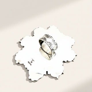 silver ring on a beige background