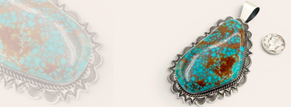 Turquoise pendant with silver setting on a white background