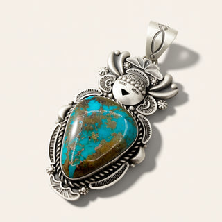 Silver pendant with turquoise stone on a white background