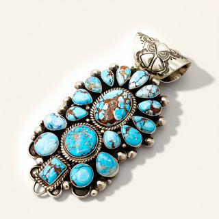 Turquoise stone pendant with silver setting on a light background
