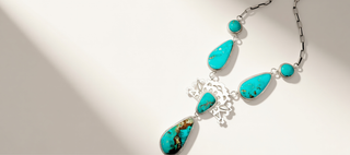 turquoise necklace on a beige background banner