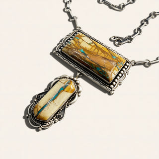 Silver necklace with two pendant stones on a white background