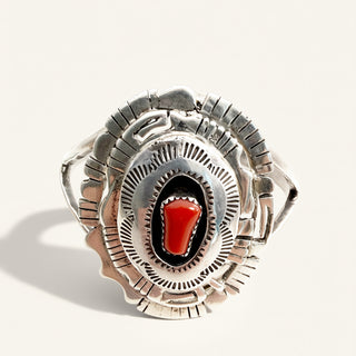 sterling silver cuff with red stone on a beige background