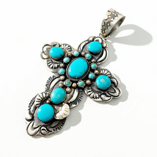 Silver Cross Pendant with turquoise stones on a white background