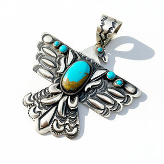 Silver Bird Pendant with turquoise stones on a white background