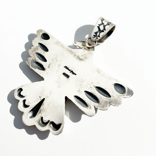 Back of a silver bird stamped with Richard Yazza