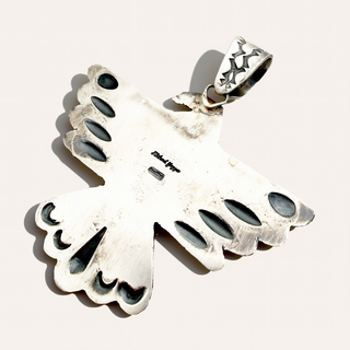 Back of a silver bird stamped with Richard Yazza