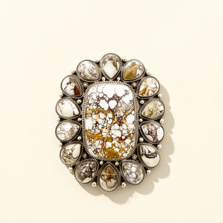 Decorative cuff with crystal-like stones on a beige background