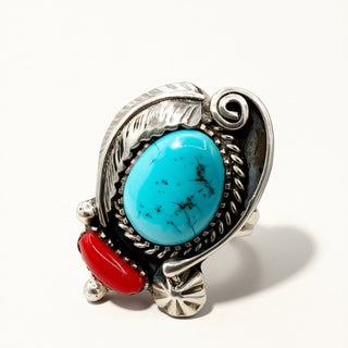 Silver ring with turquoise and red stone on a white background
