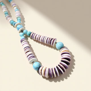 Necklace with multicolored beads on a beige background