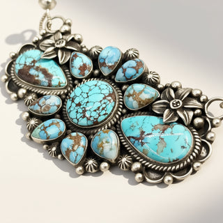 Turquoise stone and silver pendant on a white background