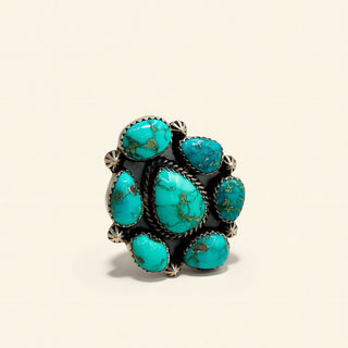 Turquoise stone ring on a beige background