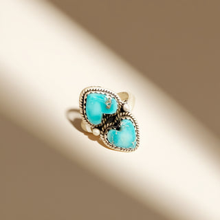 Ring with turquoise stones on a beige background