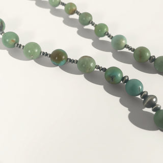 Necklace with green beads on a white background